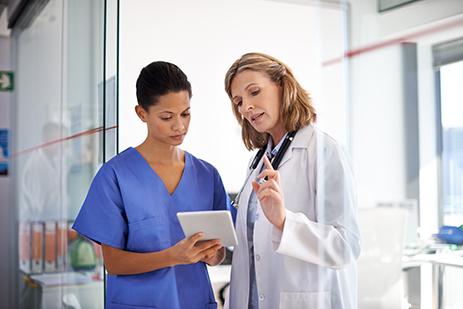 female doctor consulting with female nurse